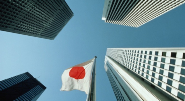Japan, Tokyo, West Shinjuku, office buildings and flag, low angle view